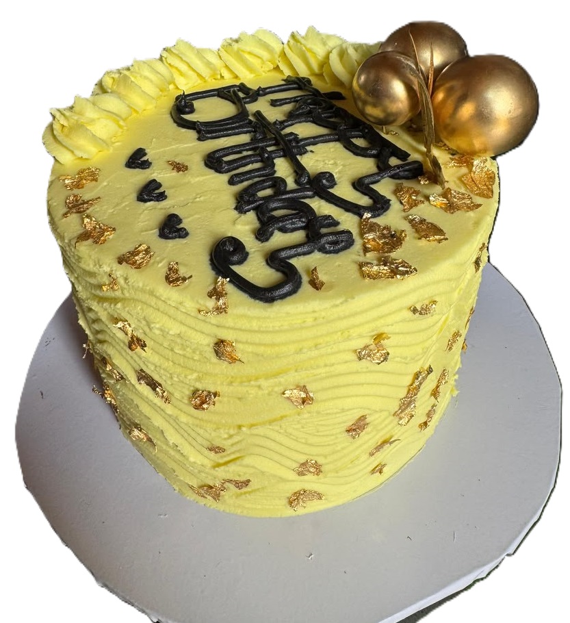 Yellow buttercream cake with gold leaf detail